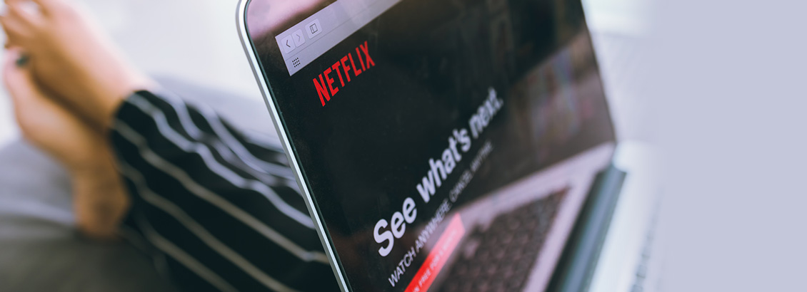Plano Cercano de Pantalla de Ipad con Netflix Encima del Regazo de una Persona